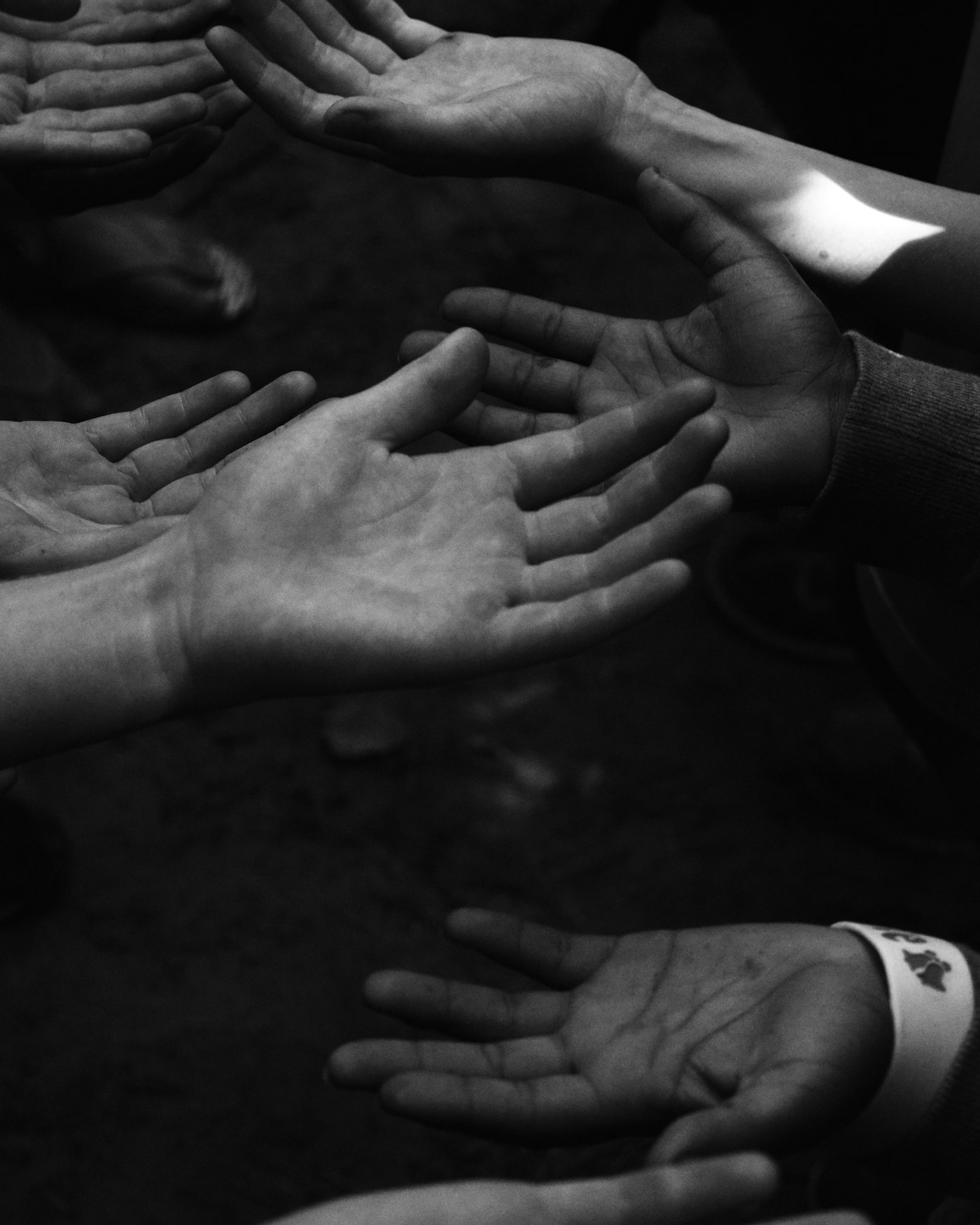 Two people's hands clasped together in a gesture of comfort